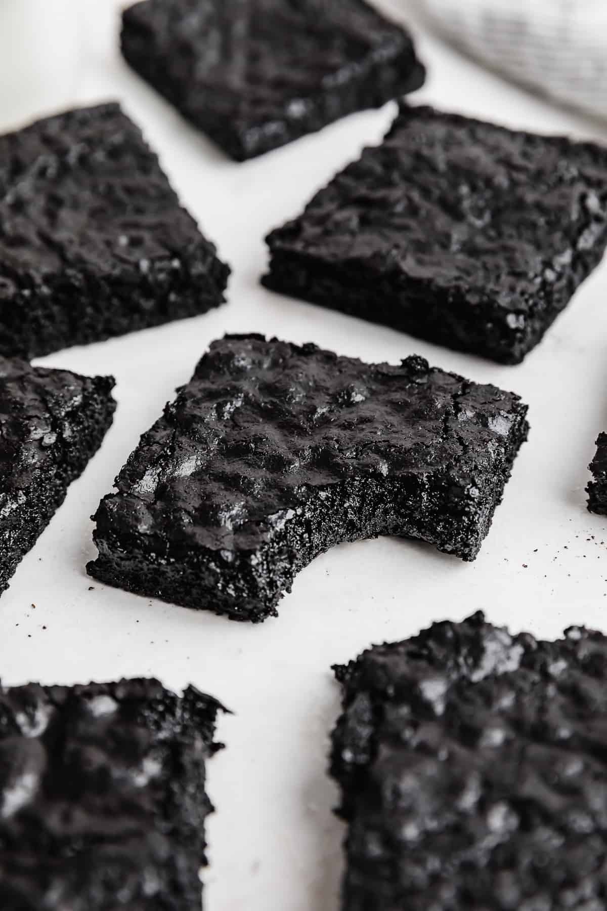 A square of Black Cocoa Brownies with a bite taken out of it.
