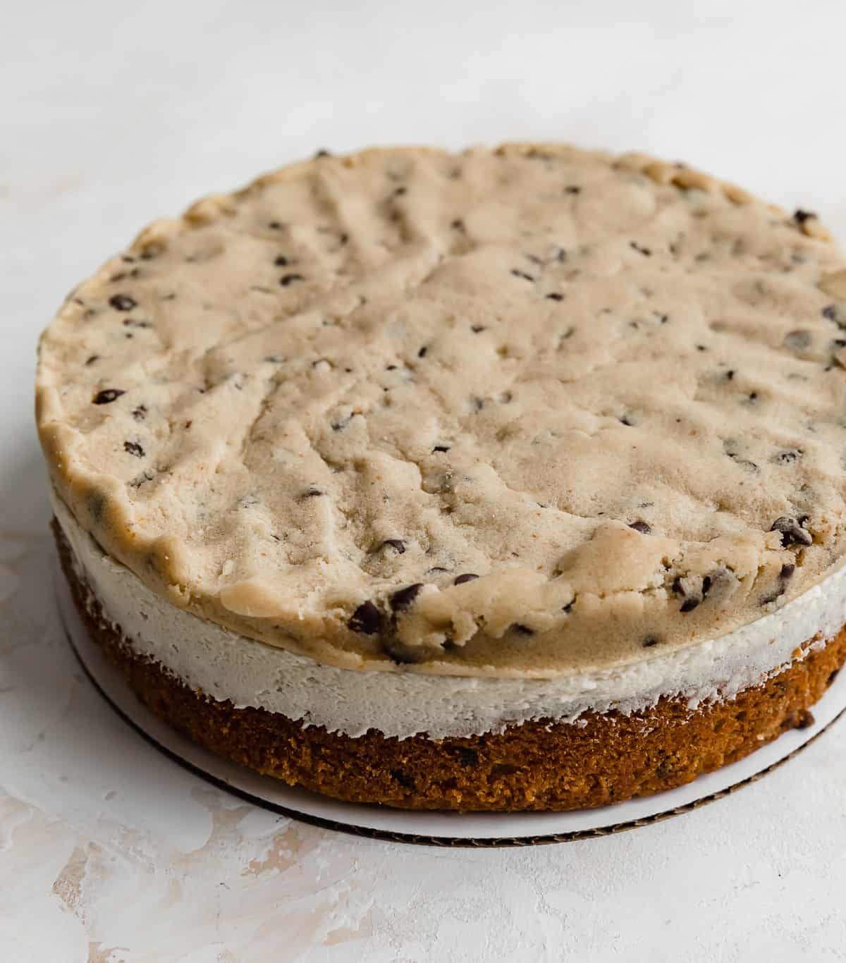 Edible cookie dough layer on top of a frosting coated cake layer.