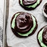 Crumbl Mint Brownie Cookies on a white parchment paper.