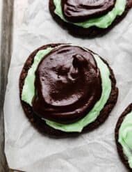 Crumbl Mint Brownie Cookies on a white parchment paper.