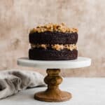 A photo of a two layer German Chocolate Cake with coconut pecan frosting between the layers.