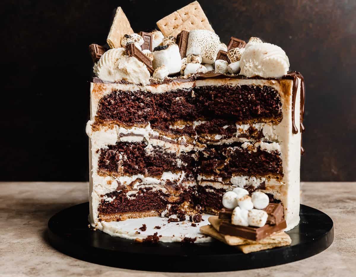 A quarter of a S'mores Cake cut, showcasing the inside of the three tiered cake. 