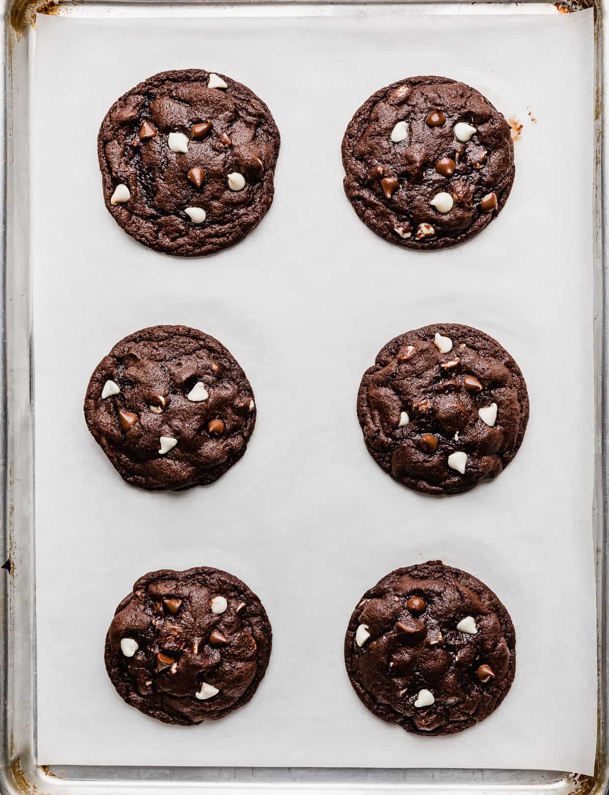 Baked Triple Chocolate Chip Cookies on a baking sheet.
