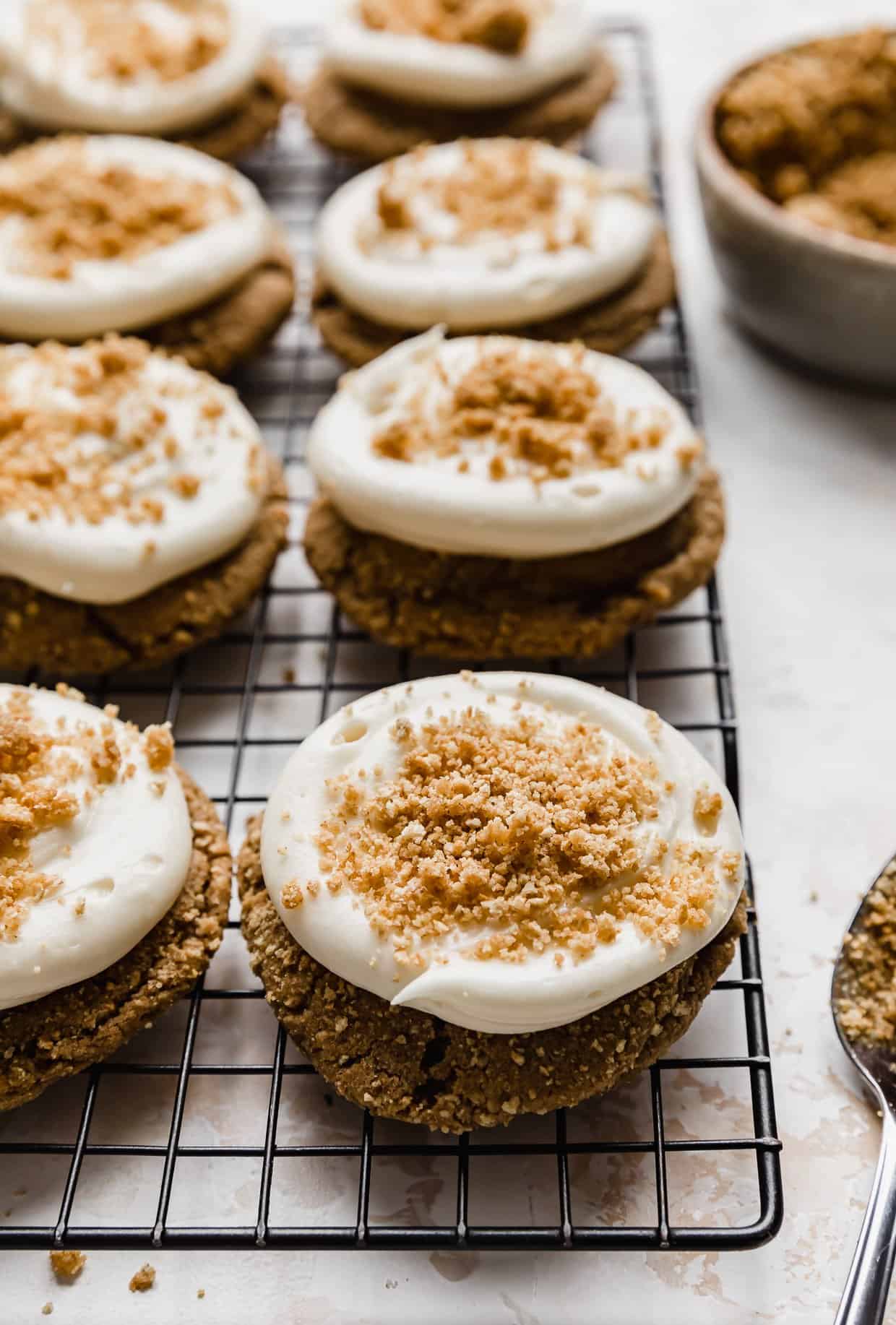 Crumbl New York Cheesecake Cookies with frosting on top of each cookie and graham cracker sprinkled overtop.