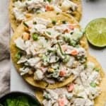Mexican chicken salad on a tostada with cilantro for garnish.