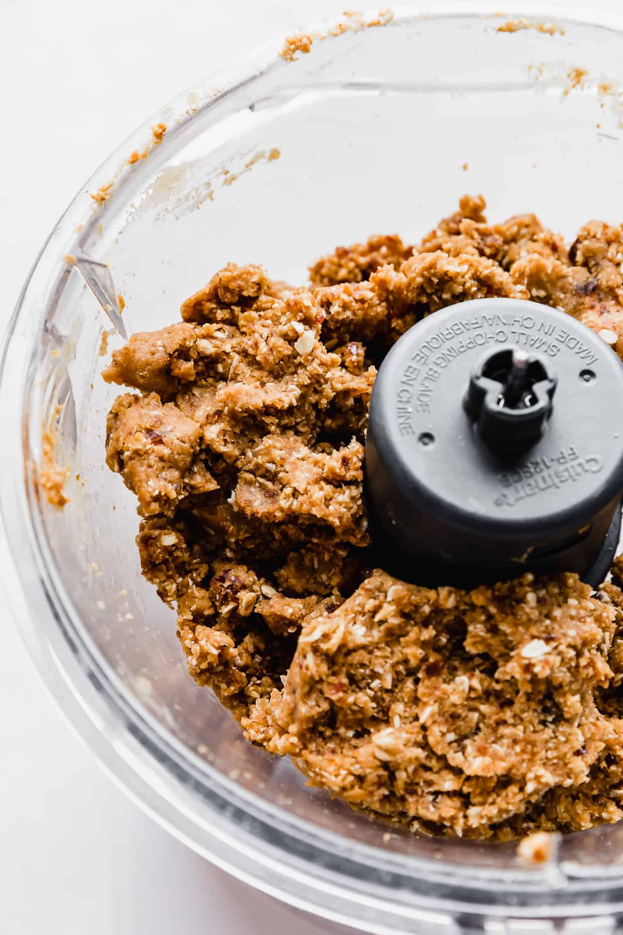 Close up photo of Peanut Butter Bliss Balls made with dates mixture in a food processor.