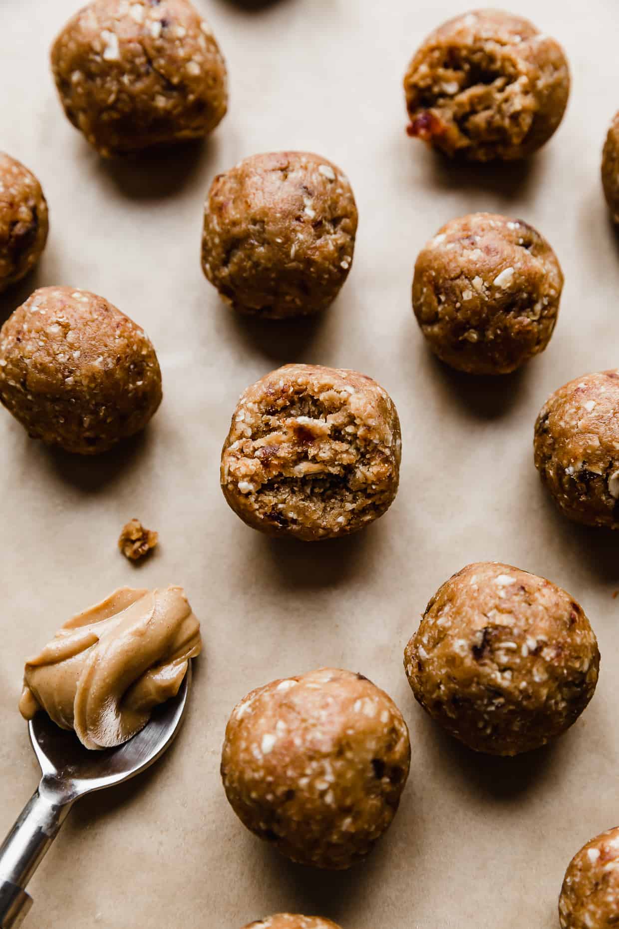 A Peanut Butter Bliss Ball with a bite taken out of it.