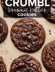 A crackly top brownie cookie on a tan background with the words "Crumbl Brownie Batter Cookies" in white text over the photo.