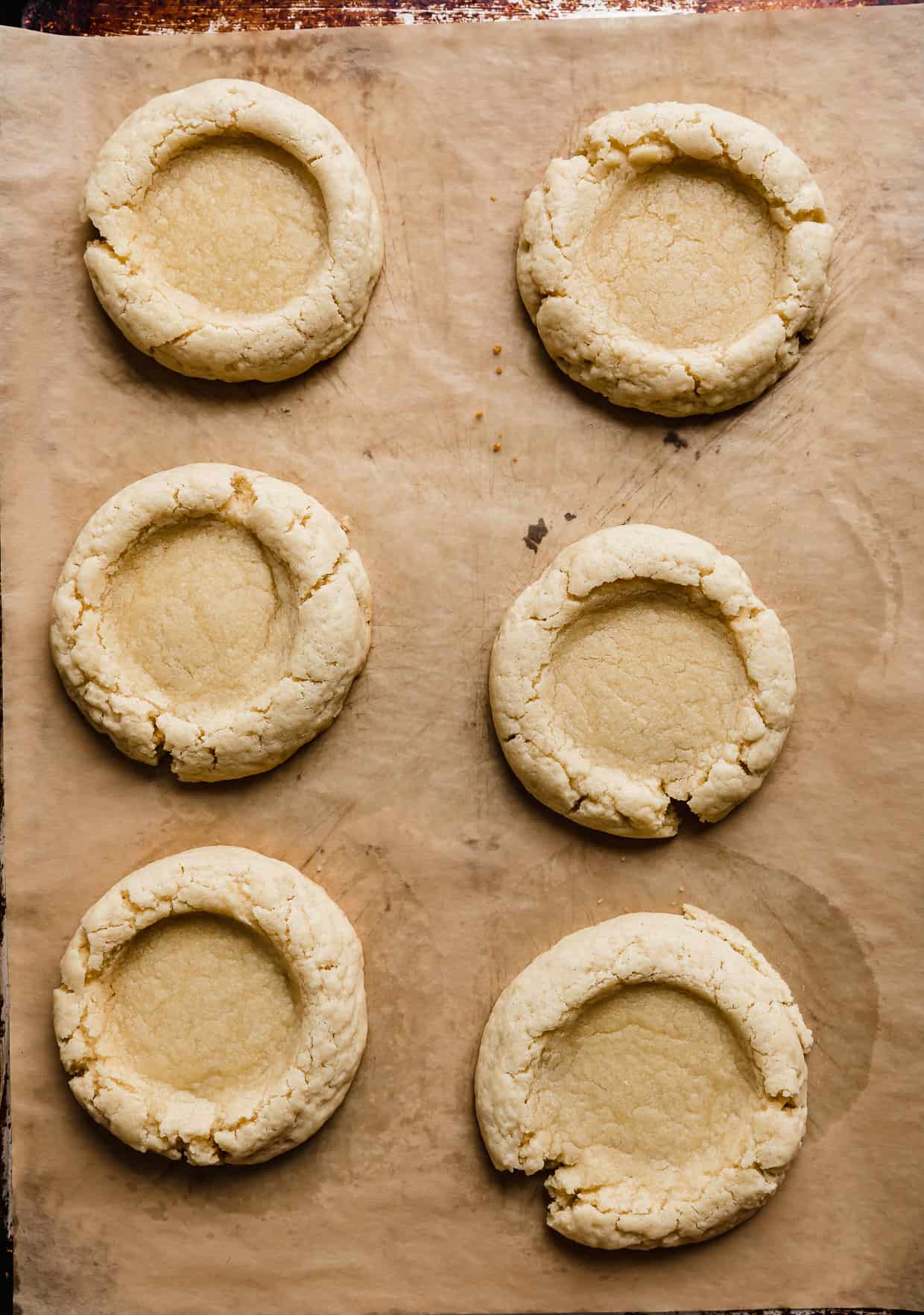 Six baked Boston Cream Pie Cookies on a baking sheet.