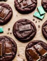 Chocolate Andes Mint Cookies on a tan parchment paper.