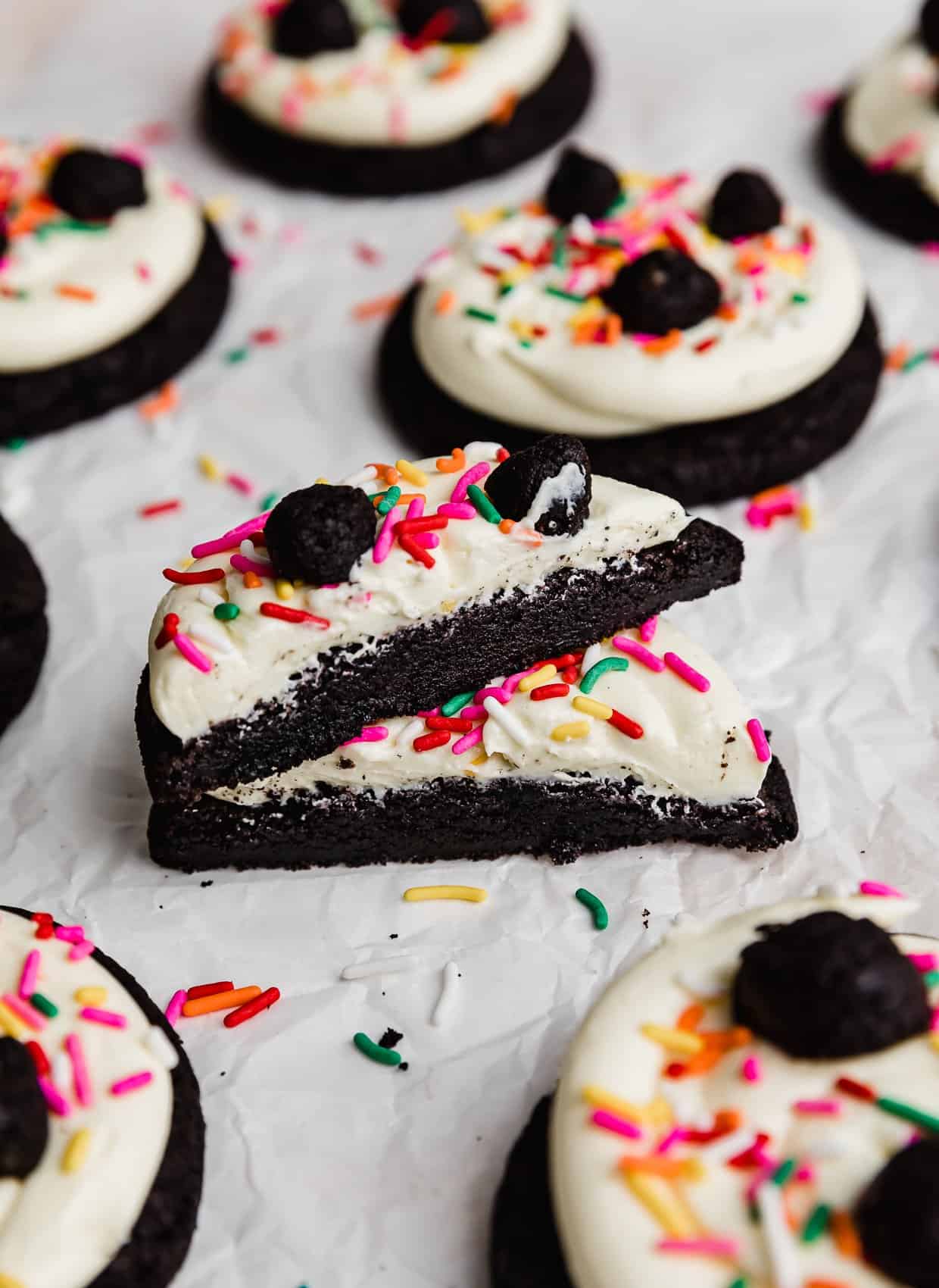 Oreo Birthday Cake Cookies topped with white frosting, colorful sprinkles, and oreo truffles.