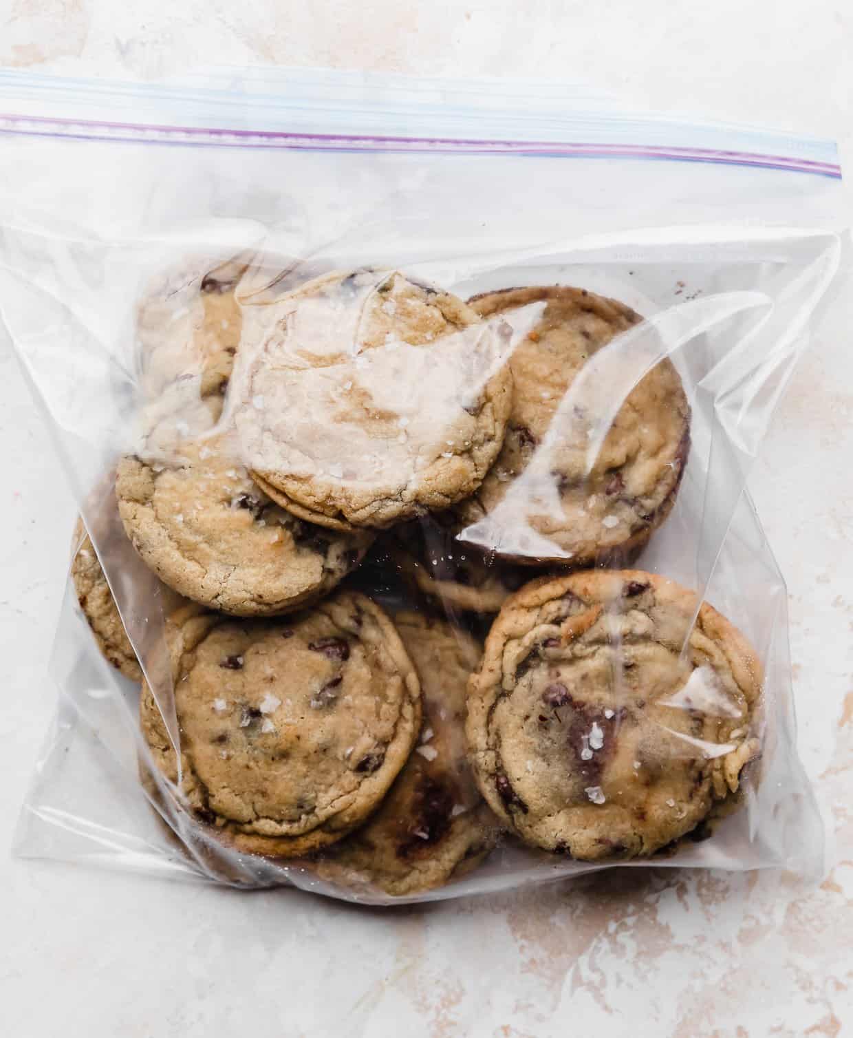 A ziplock bag filled with baked chocolate chip cookies.