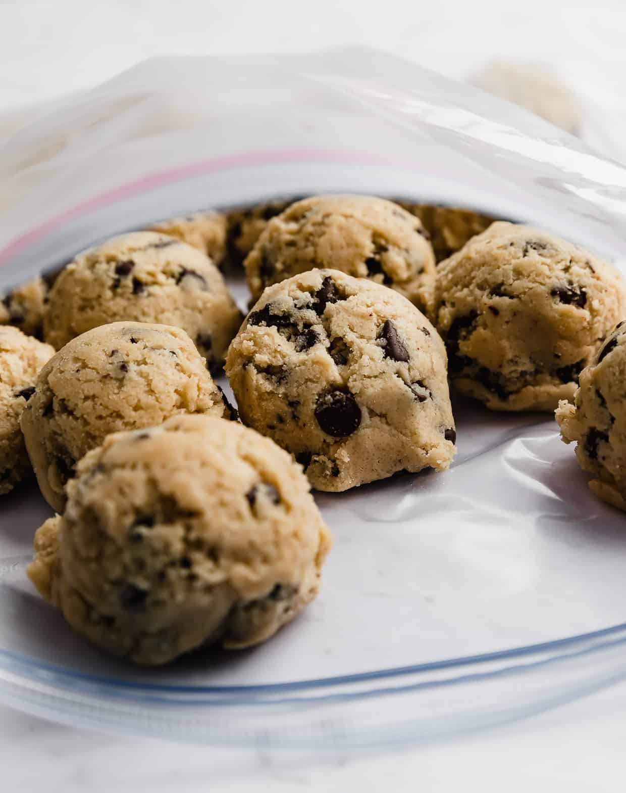 How to freeze cookie dough balls: chocolate chip cookie dough balls in a ziplock bag.