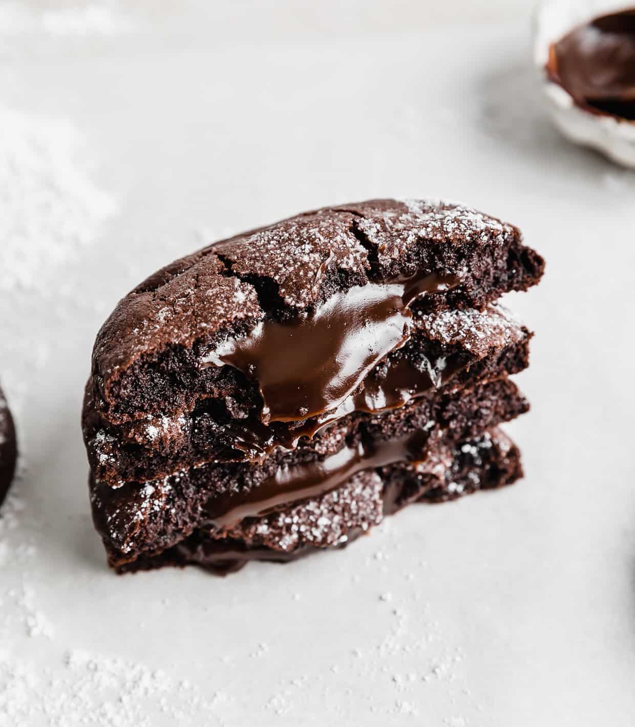 Copycat Crumbl molten lava cookies cut in half with hot fudge in the centers.