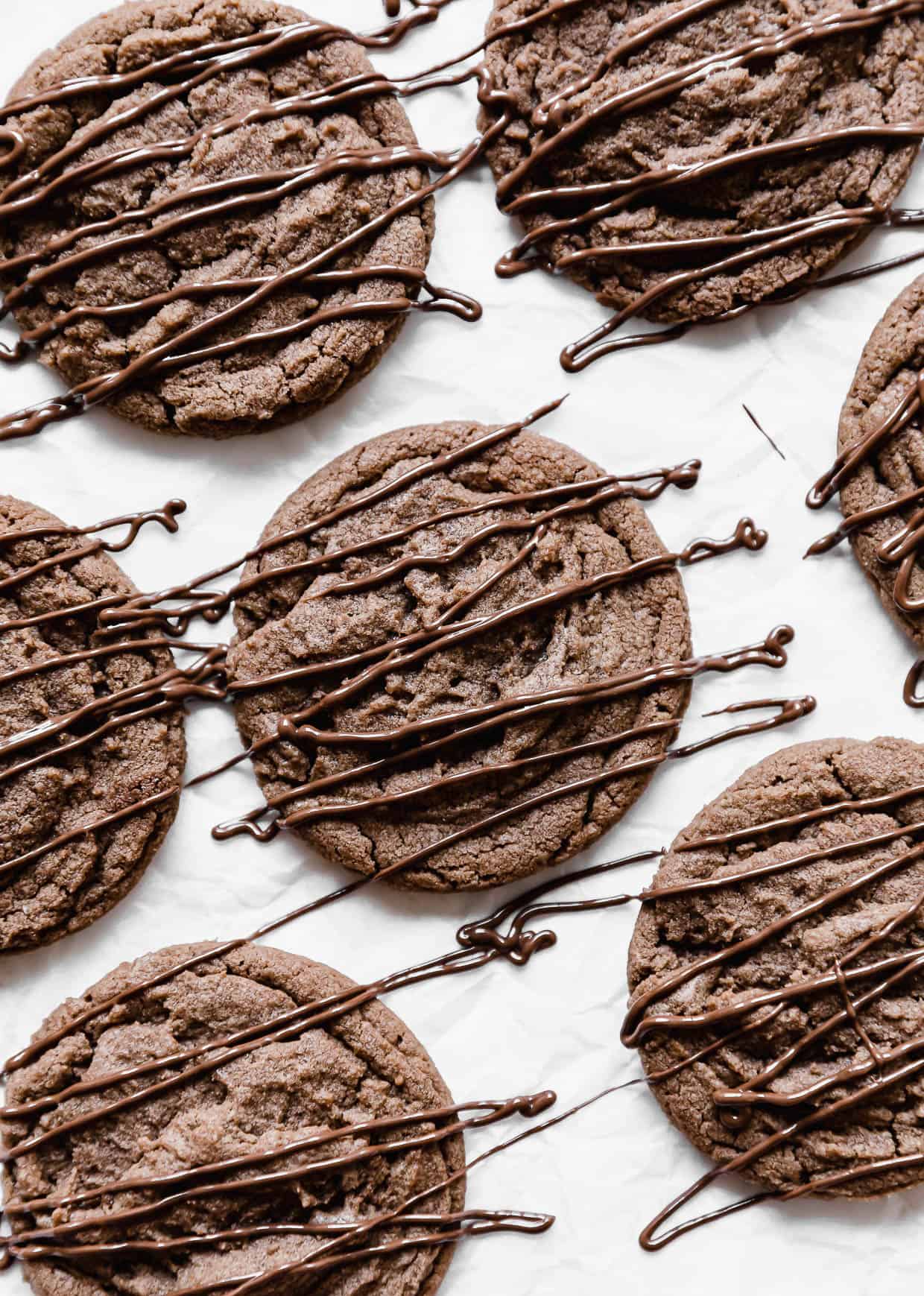 Nutella Cookies drizzled with nutella, on a white background.