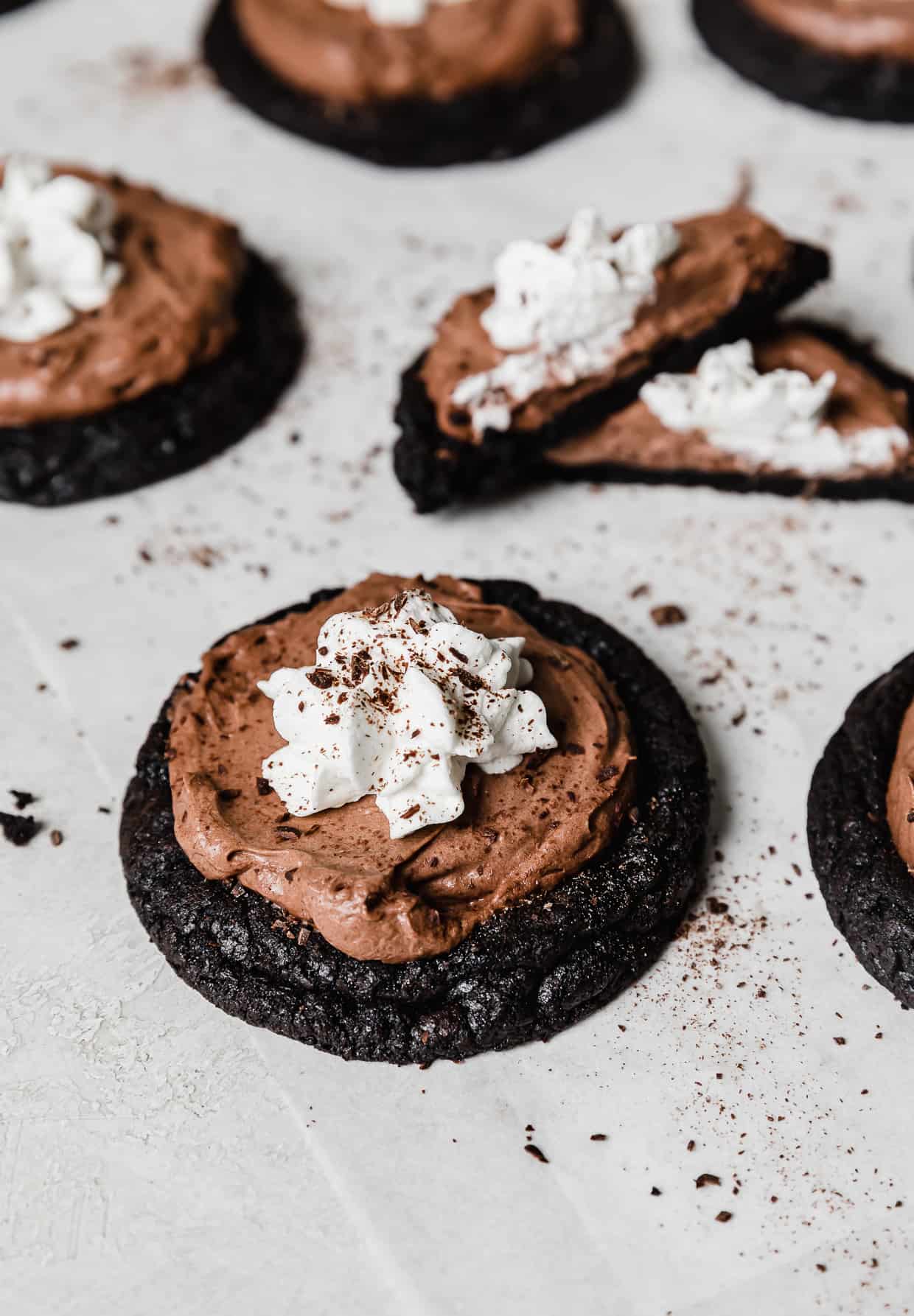 An oreo cookie base topped with a chocolate mousse and whipped topping to look like a French Silk Pie Cookie.