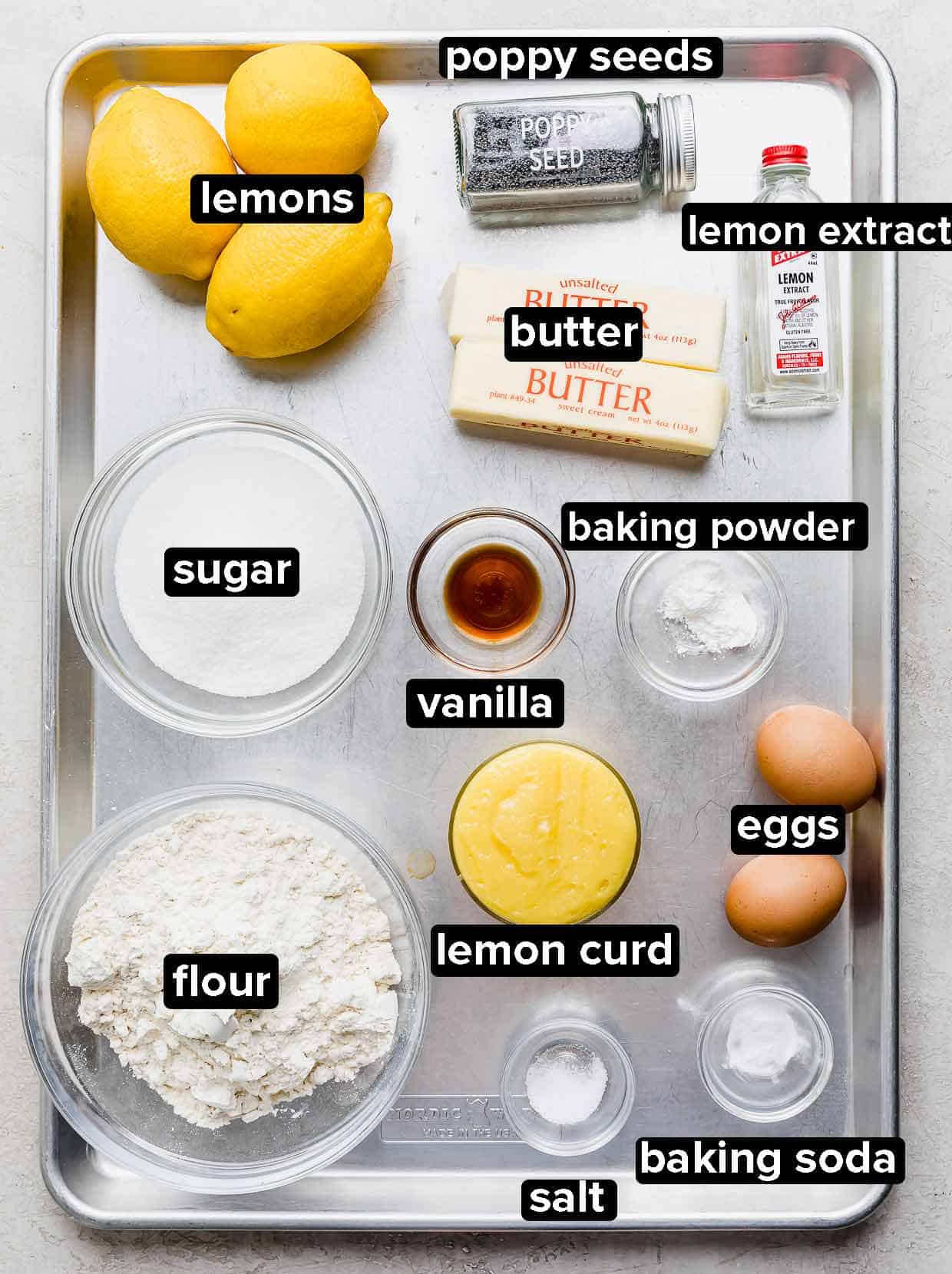 Lemon Poppy Seed Cookie ingredients portioned into glass bowls on a baking sheet.