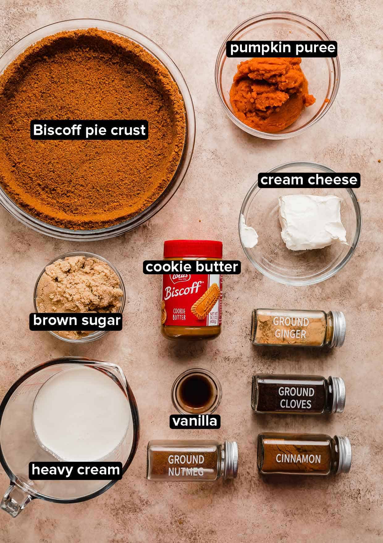 Biscoff Pumpkin Pie ingredients on a beige background.