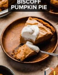 A slice of cookie butter pumpkin pie with a fork cutting into the slice.