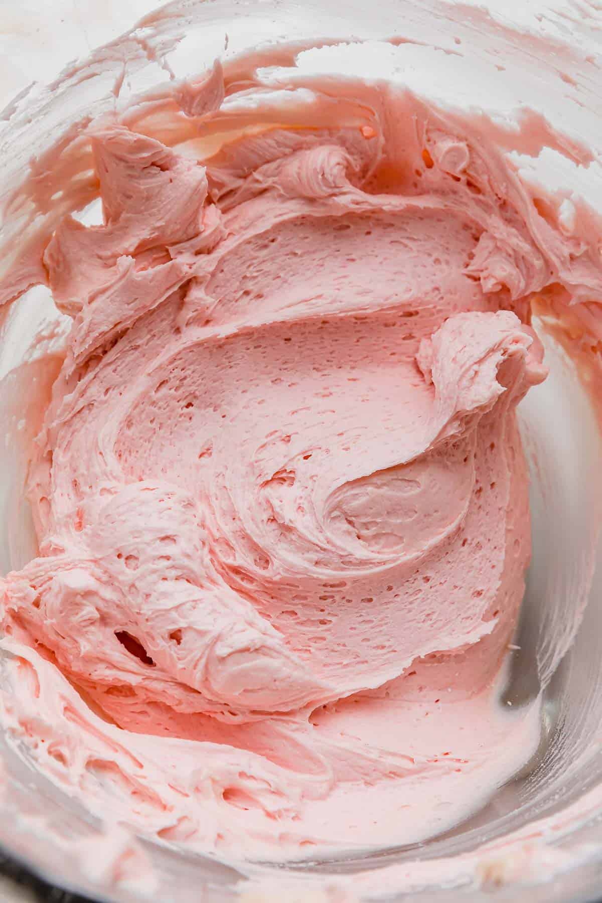 Pink Sugar cookie buttercream frosting in a glass bowl.