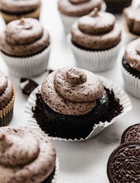 Oreo Cupcakes on a white background, each cupcake topped with a swirl of Oreo frosting.