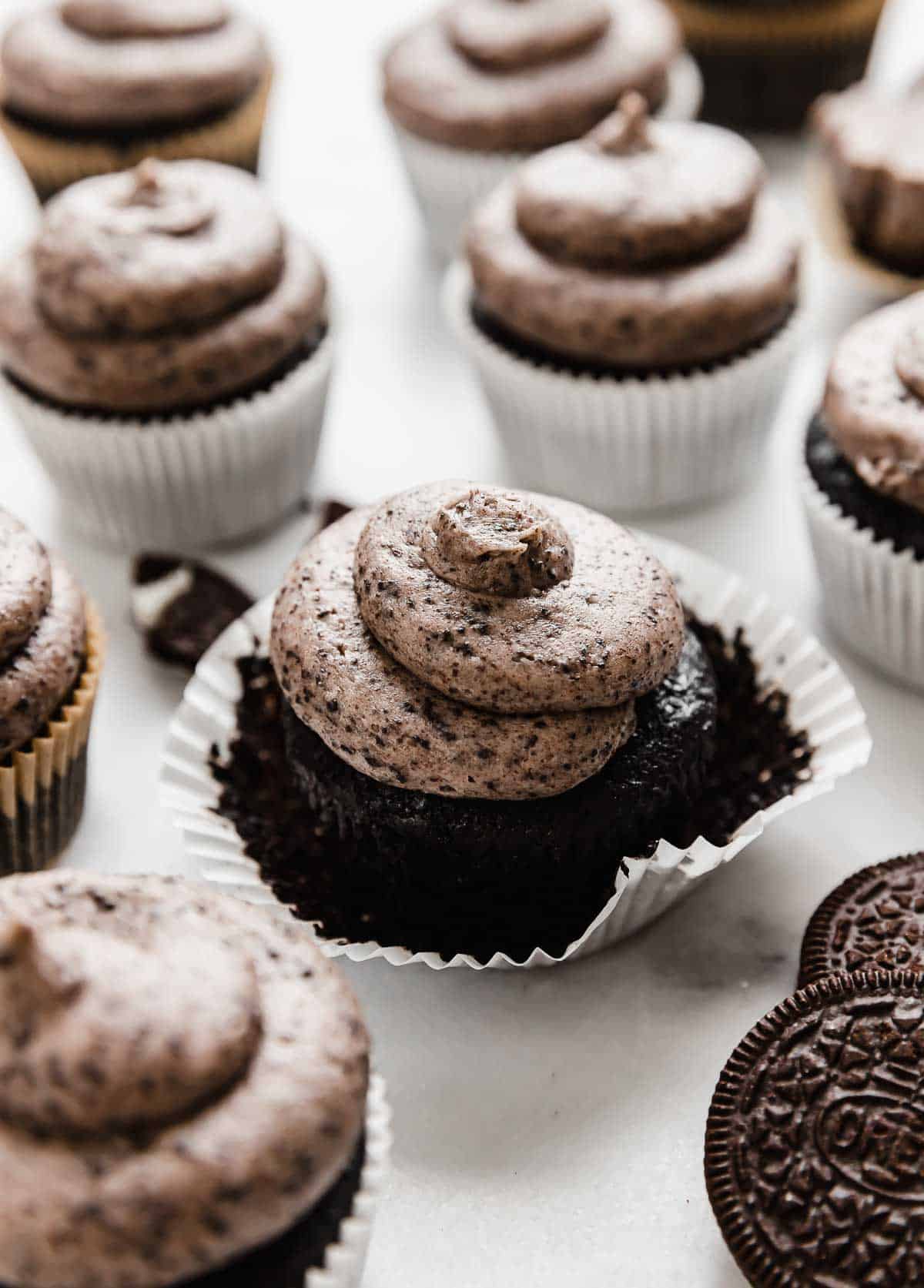 Oreo Cupcakes on a white background, each cupcake topped with a swirl of Oreo frosting.