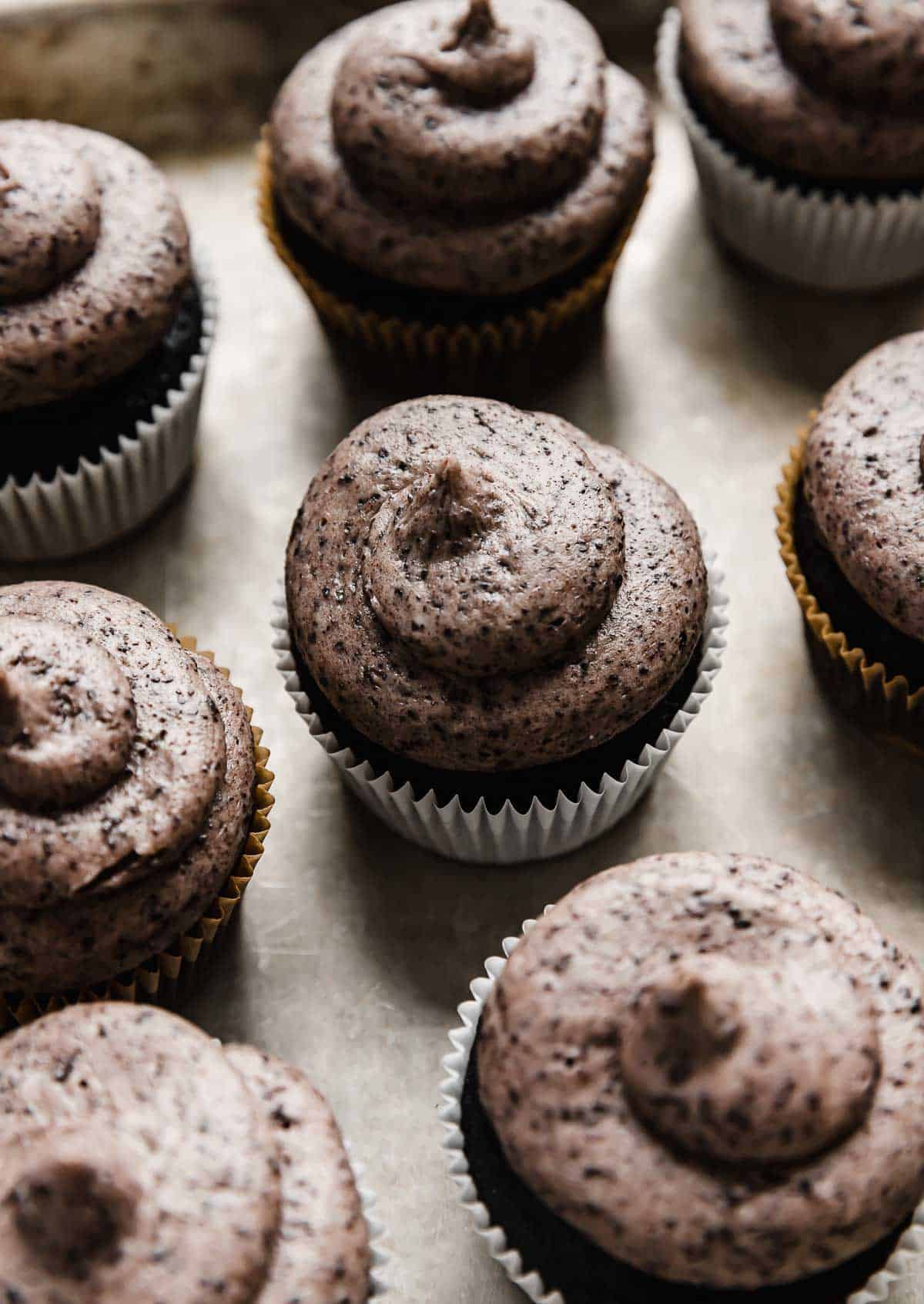 Oreo Frosting swirled on top of a black cupcake.