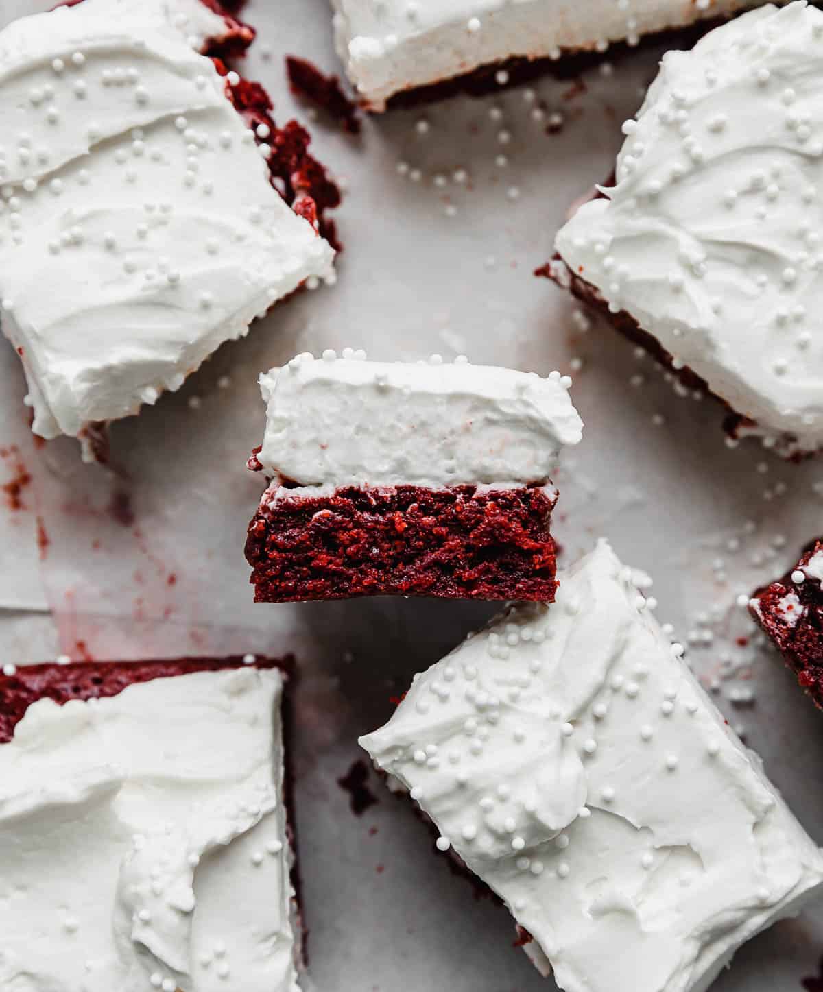Red Velvet Brownies with cream cheese frosting on a white background.