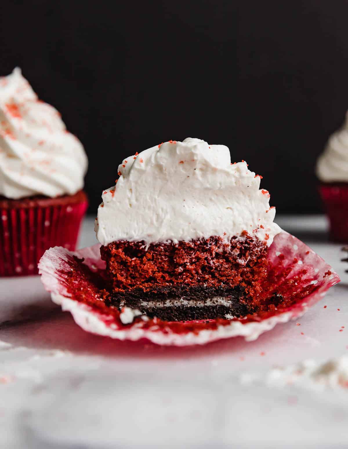 A red velvet cupcake baked on top of an Oreo.