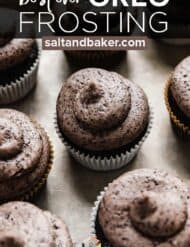 Black cupcake topped with a homemade swirled Oreo frosting with the words, "best ever Oreo frosting" in white text over the photo.