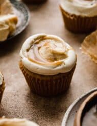 A Butterscotch Cupcake on a light brown background.