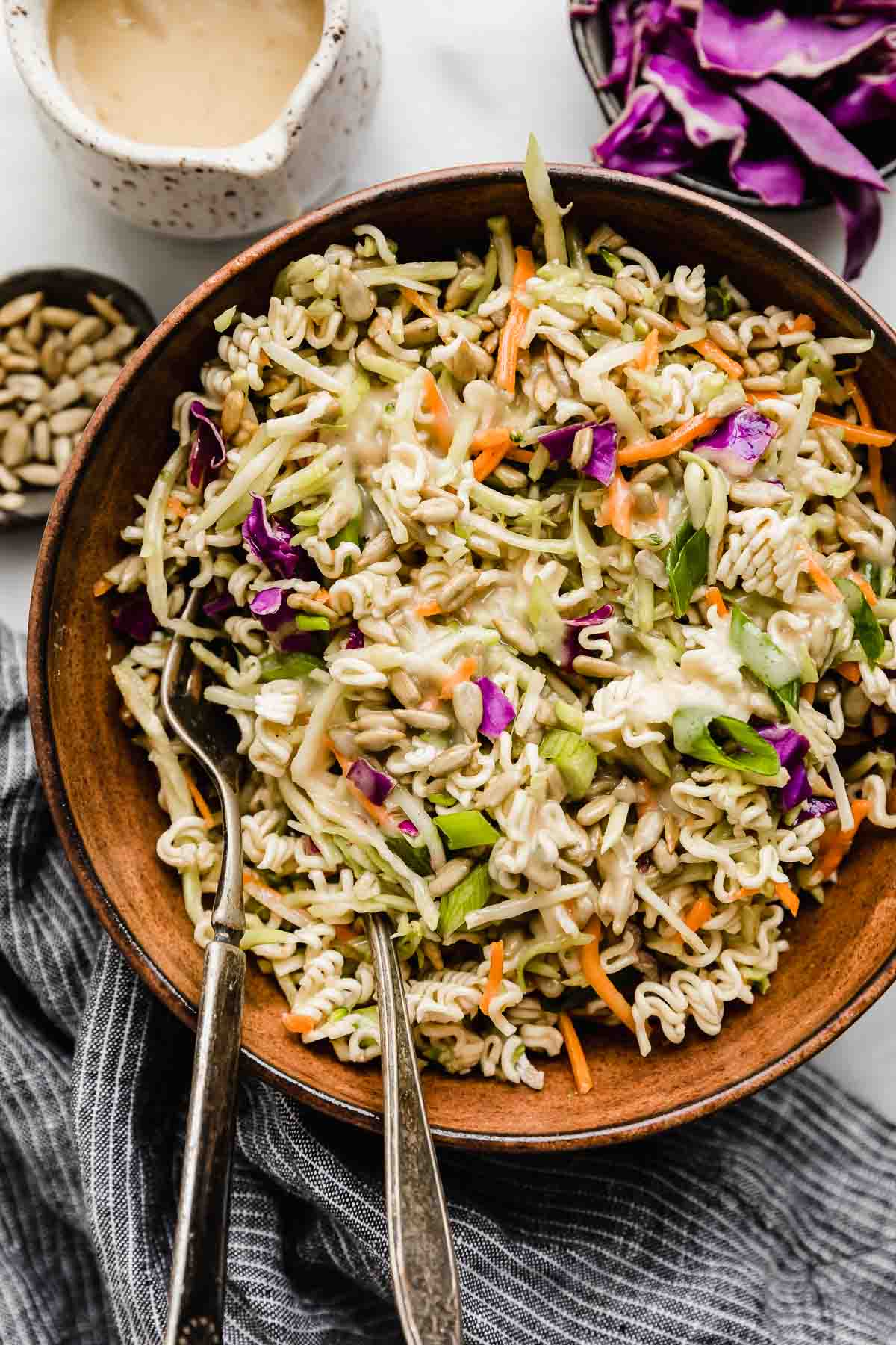 Close up photo of Asian Broccoli Slaw topped with sesame seeds and green onions.