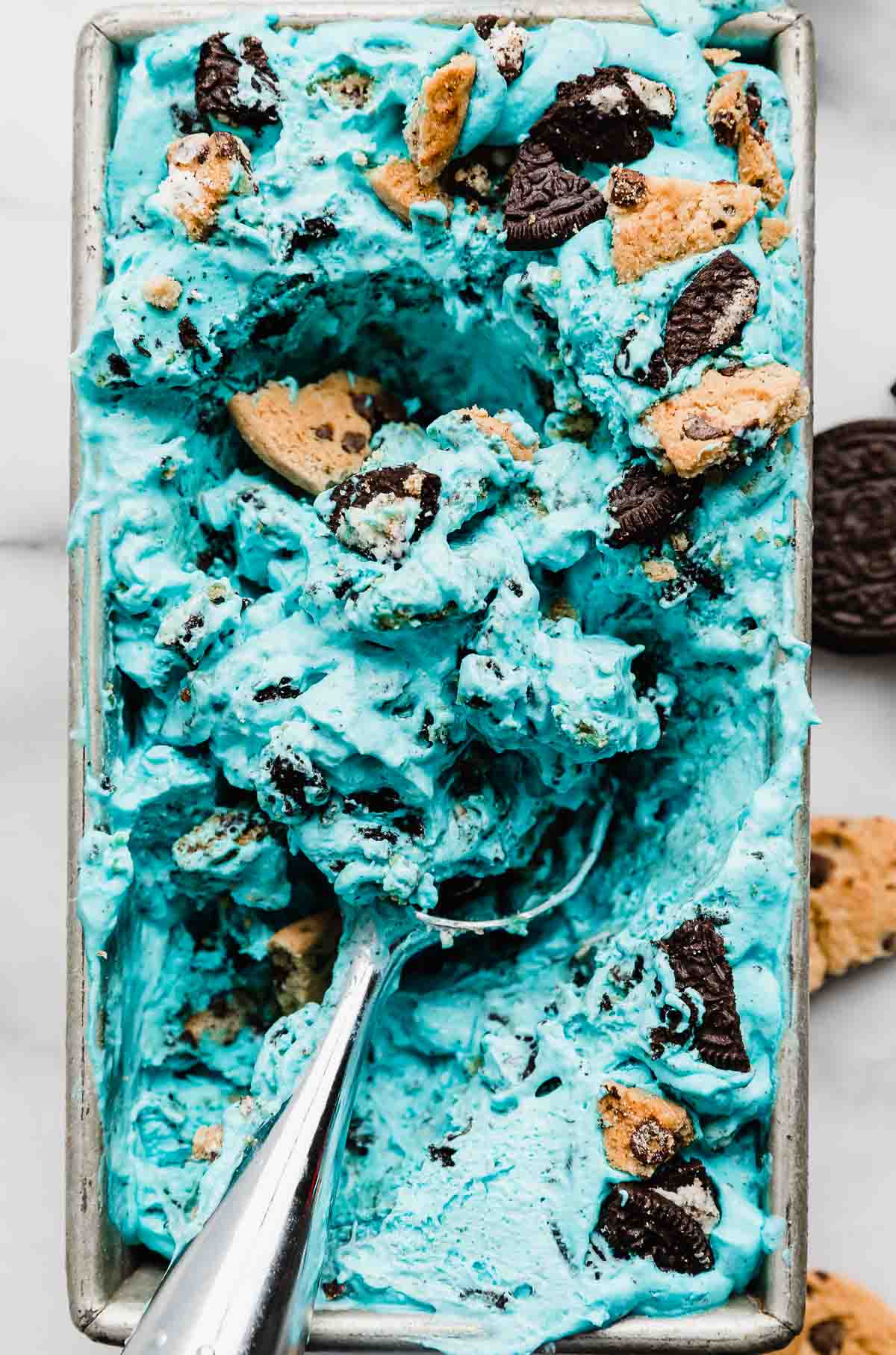 An ice cream scooper scooping up no churn blue Cookie Monster Ice Cream.