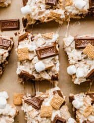 Hershey's chocolate bar and golden graham s'mores Rice Krispies treats on a Kraft background.