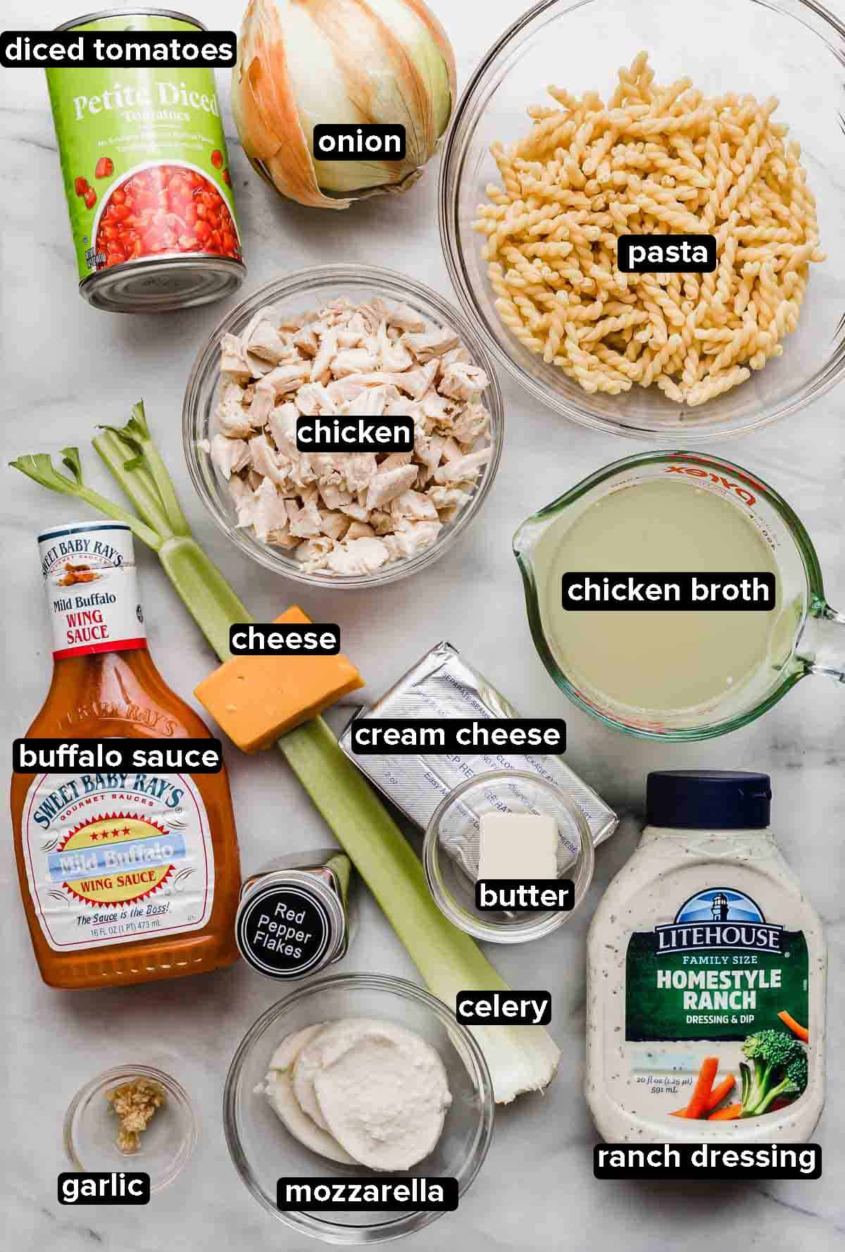 Buffalo Chicken Pasta ingredients portioned into glass bowls on a white background.