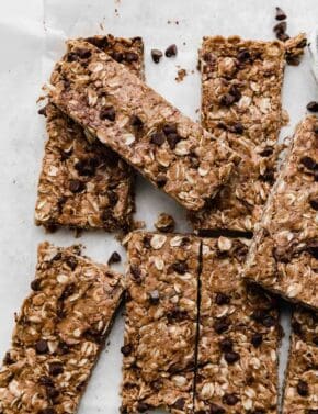 Chocolate Peanut Butter Protein Bars on a white parchment paper.
