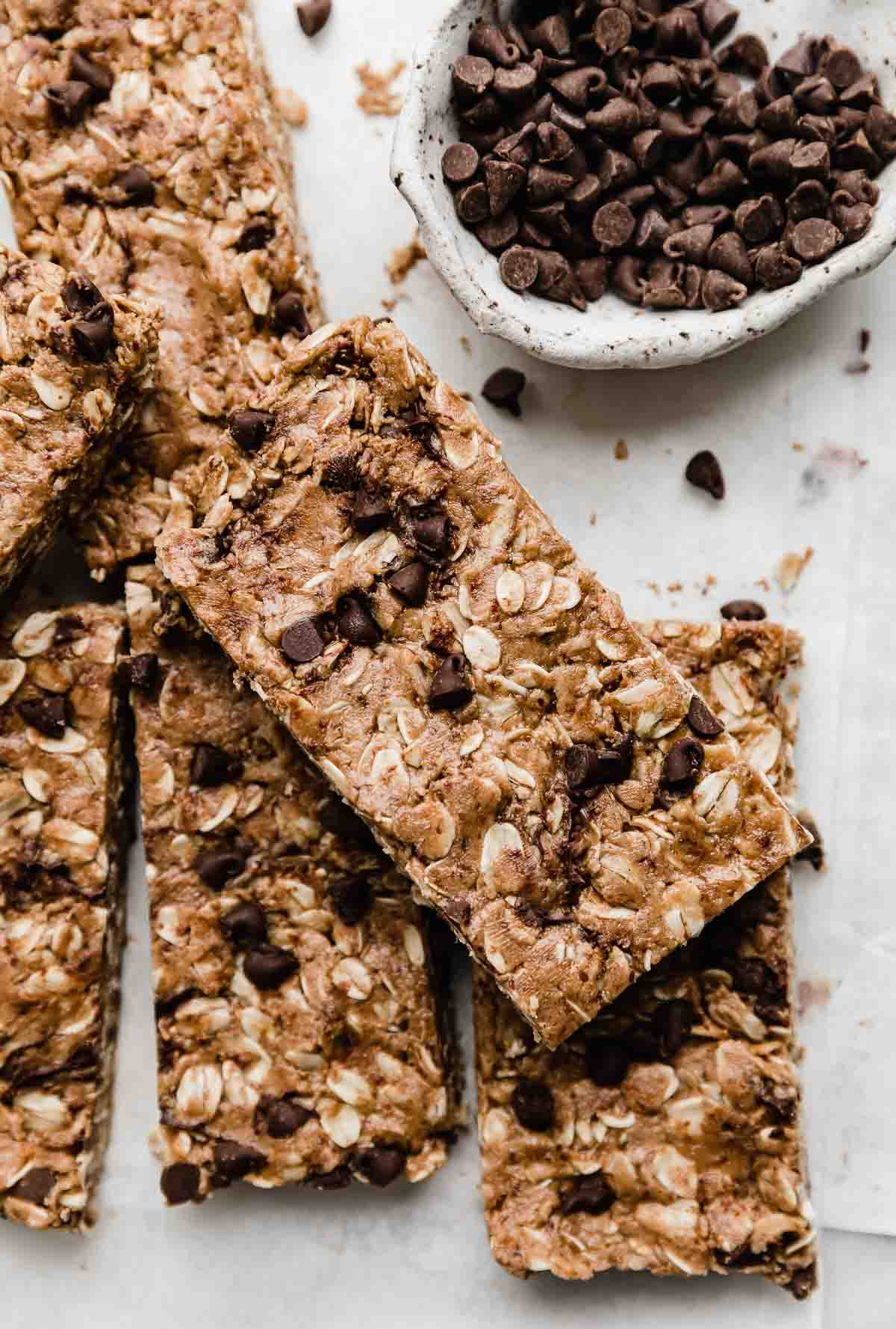 Chocolate Peanut Butter Protein Bars topped with mini chocolate chips on a white background.