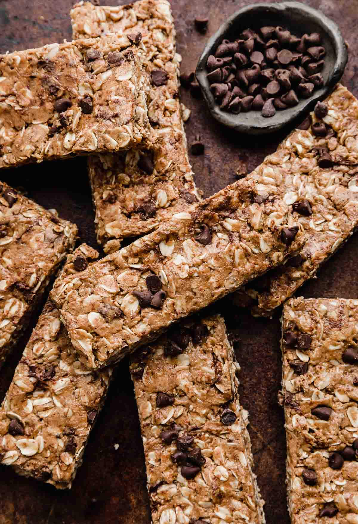 Chocolate Peanut Butter Protein Bars made with protein powder on a brown background.
