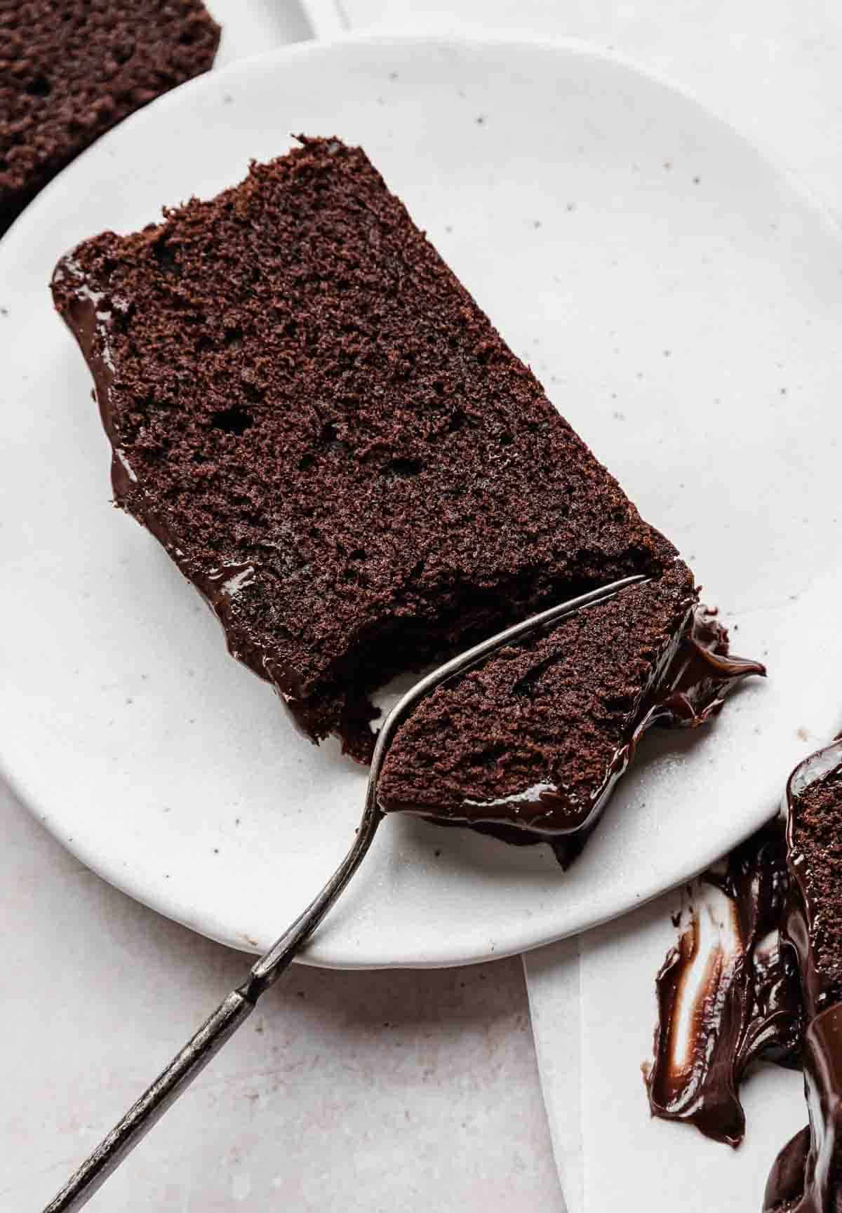 Slice of moist Chocolate Pound Cake on a white plate.