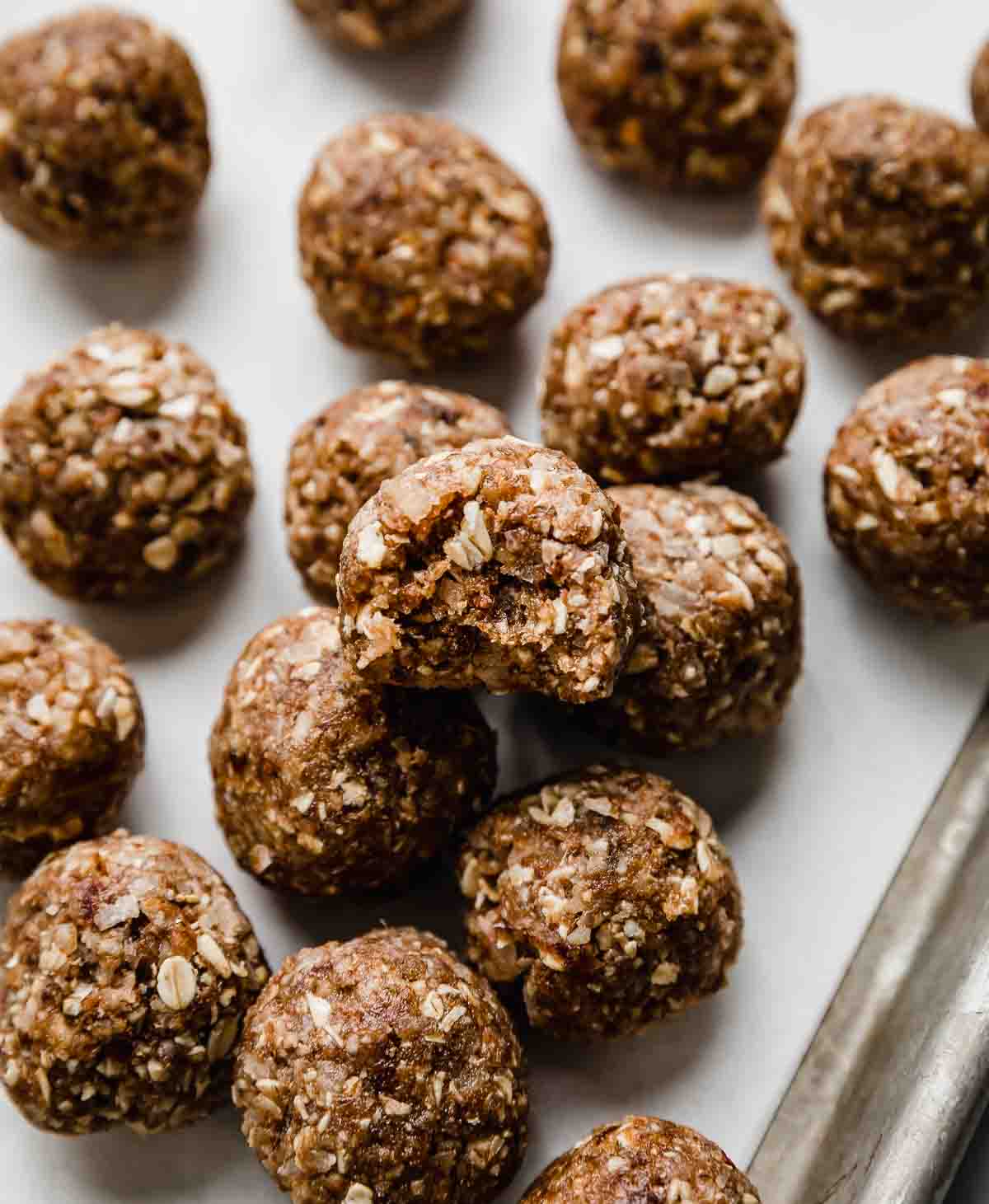 German Chocolate Cake Protein Balls on a white parchment paper.