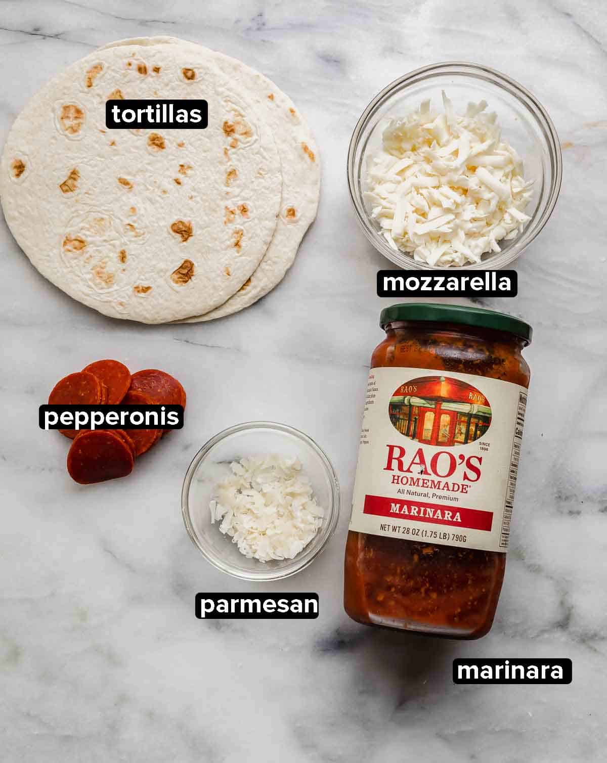 Tortilla Pizza ingredients on a white marble background: tortillas, pepperoni, mozzarella, parmesan, and marinara sauce.