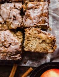 Close up photo of the best Apple Fritter Cake on parchment paper.