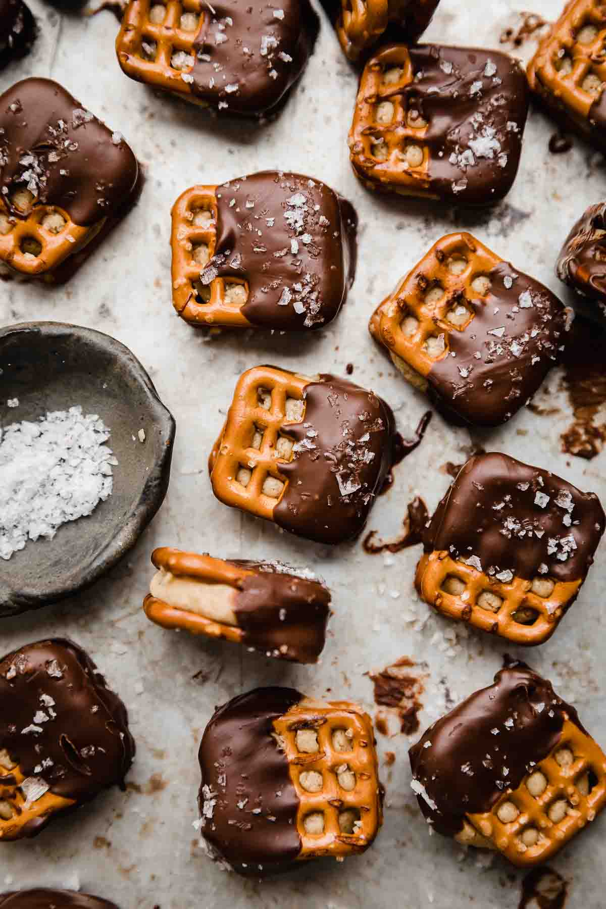 Square pretzels sandwiched with peanut butter mixture and half dipped in chocolate.