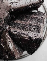 Overhead photo of a Black Velvet Cake with a slice leaning sideways against the full layered cake.