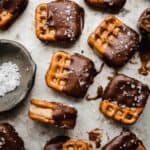 Square pretzels with a peanut butter filling sandwiched between two pretzels and then dipped halfway in chocolate.