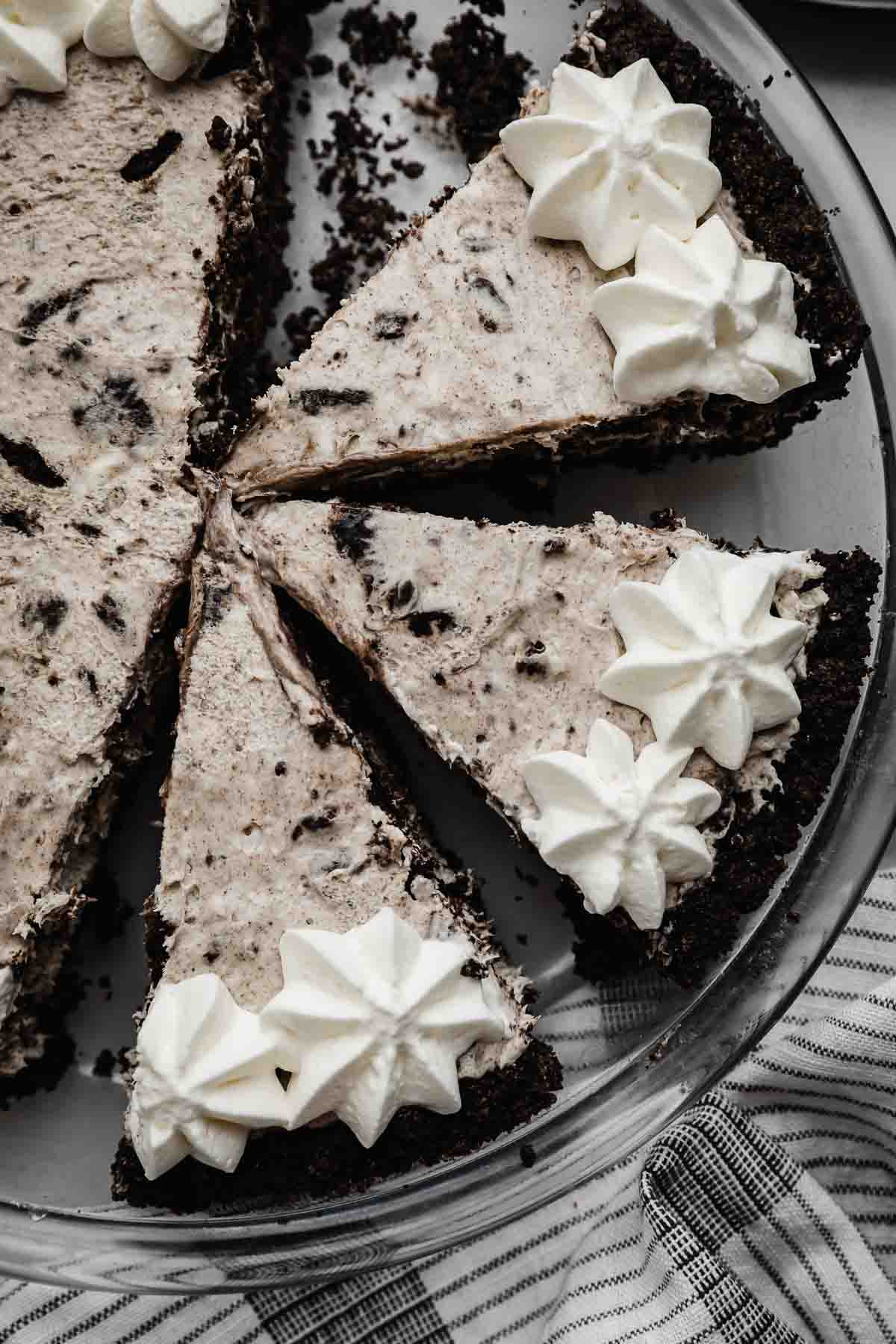 Overhead photo of three slices of Cookies and Cream Pie topped with whipped cream piped topping around the edges of the pie.