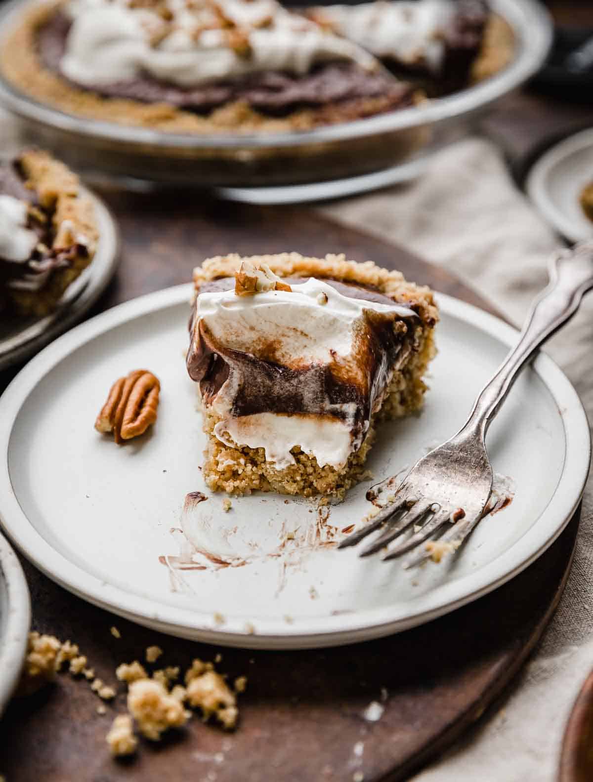 A slice of Arkansas Possum Pie on a plate with a bite taken from the pie.