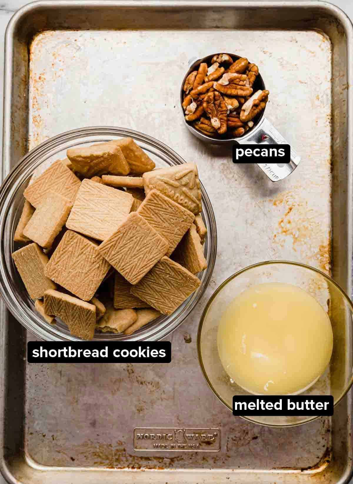 Ingredients used to make a pecan shortbread crust; shortbread cookies, pecans, and melted butter (used to make a Possum Pie recipe).