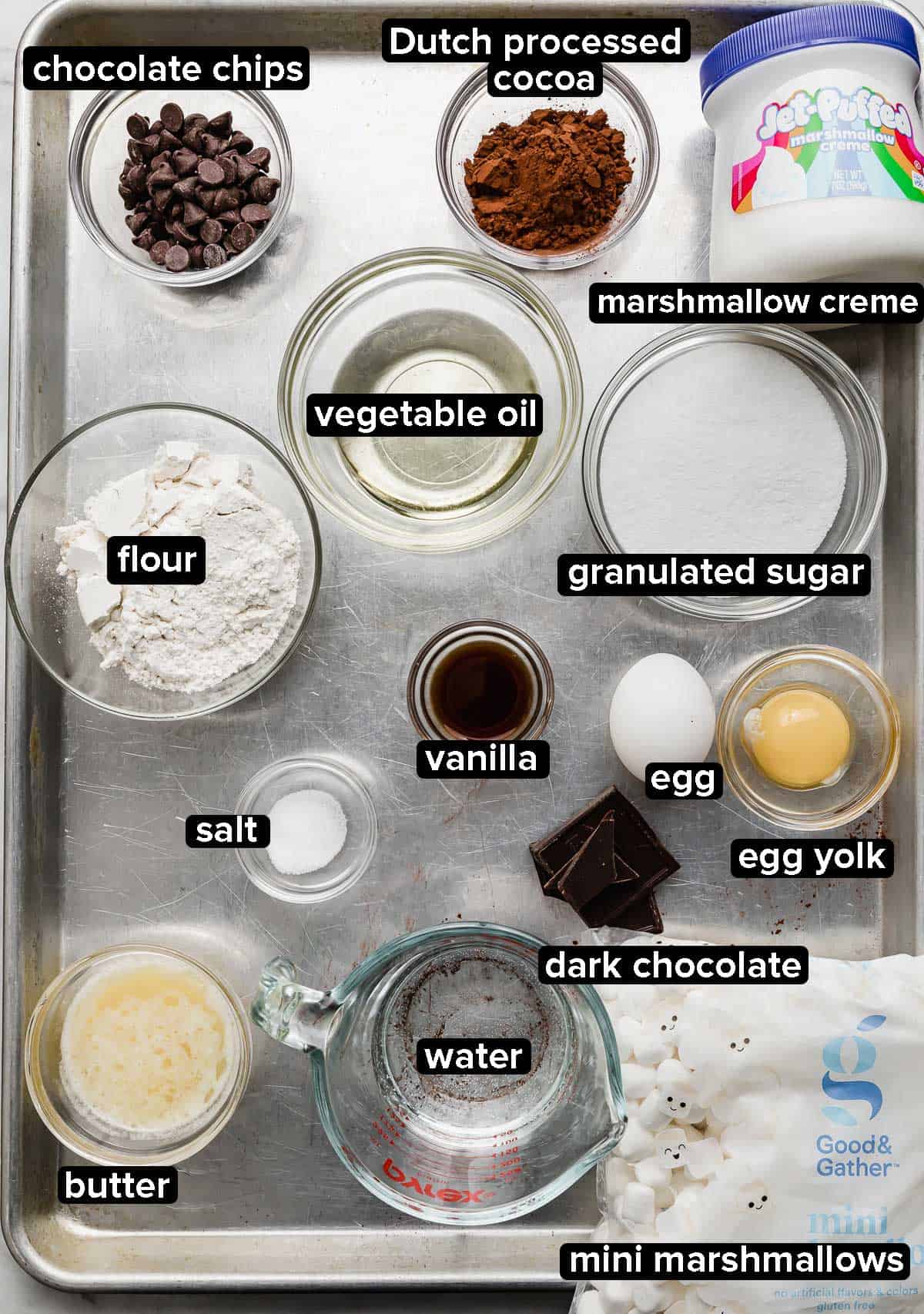 Marshmallow Brownies ingredients on a baking sheet, each portioned into glass bowls. 
