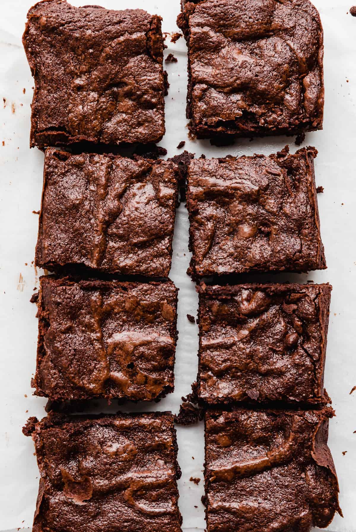 Small Batch Brownies recipe cut into 8 squares on a white background.